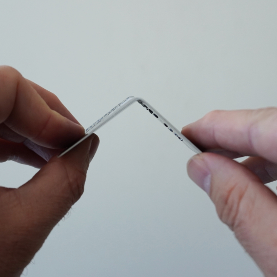 Bent credit card to show mechanics of Spondylolysis.